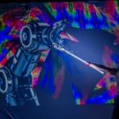 LED Show und der Jongleur steht vor einem Lightpainting Bild